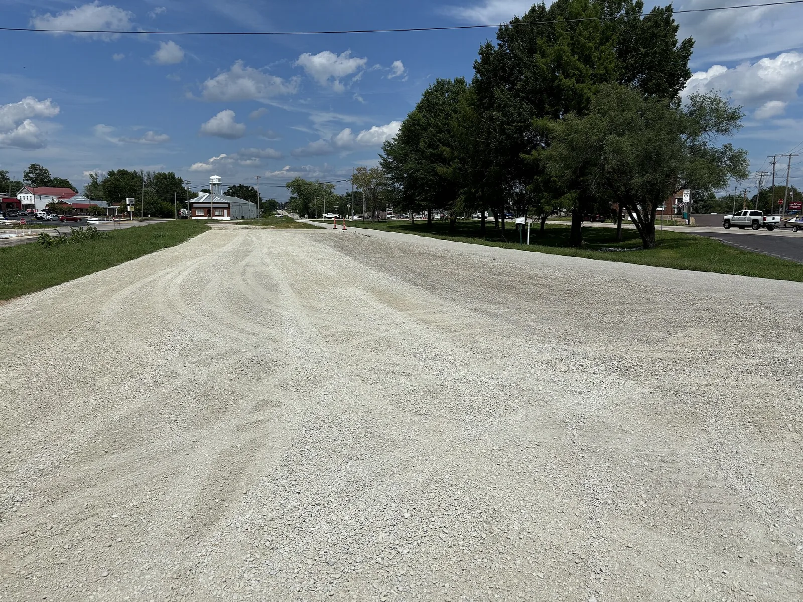 Wide gravel trail surface stretching ahead beside a roadway