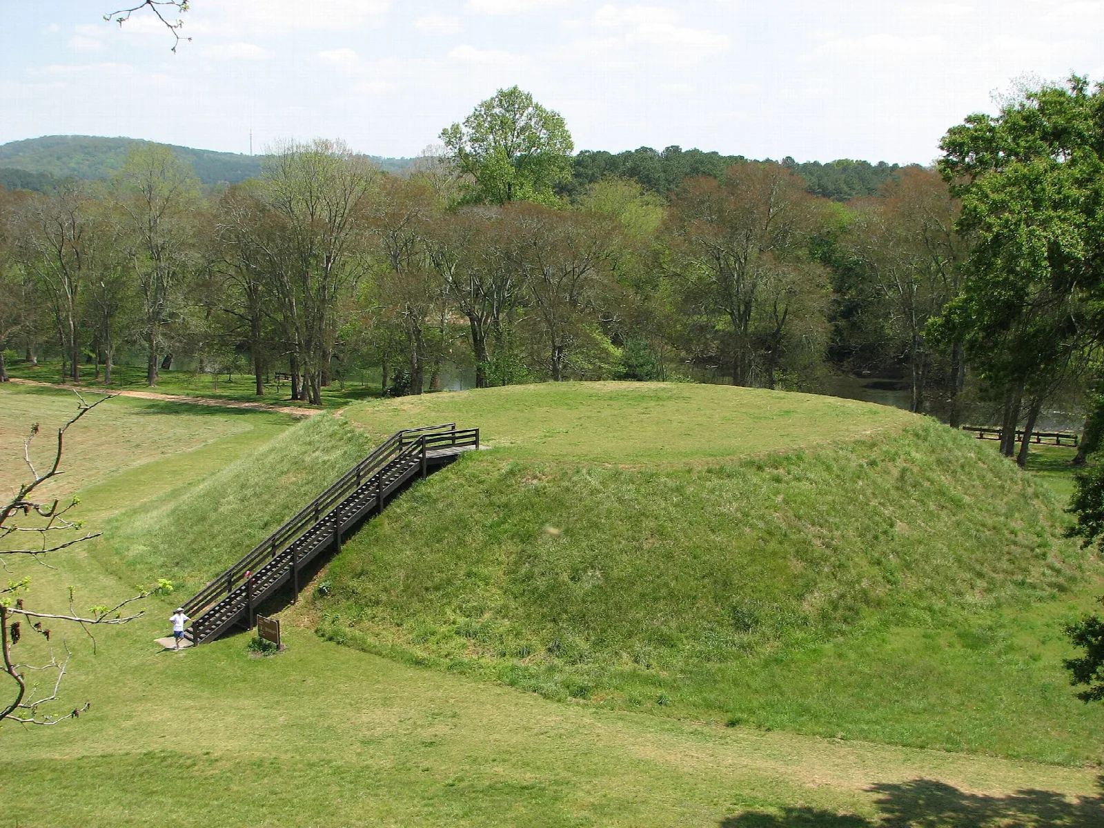 Grassy earthen mound with a wooden staircase up its side