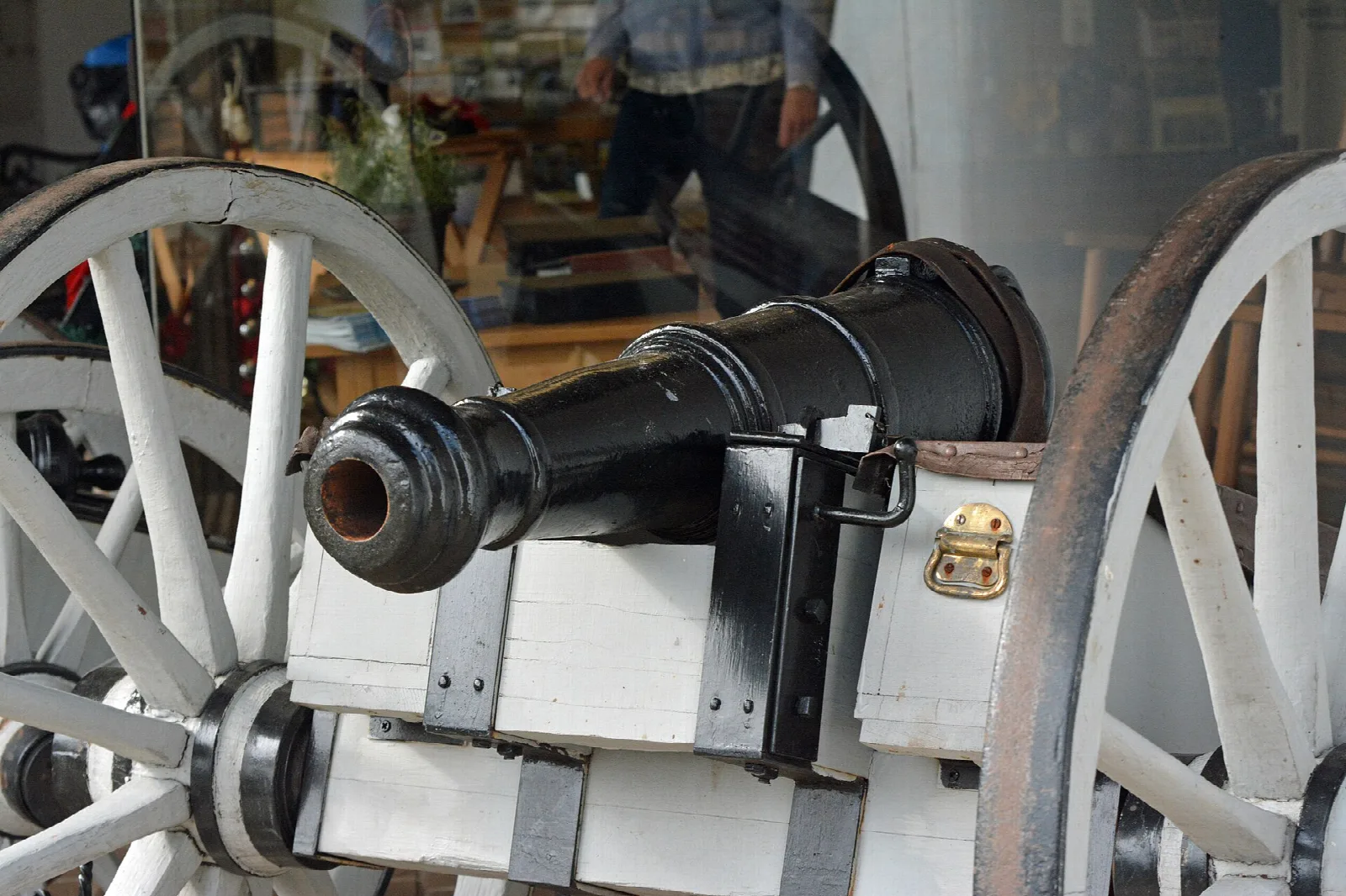 Black cannon on a white wheeled carriage