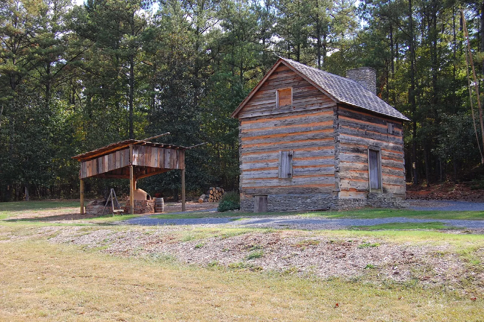 Log cabin fort with an open shed beside it