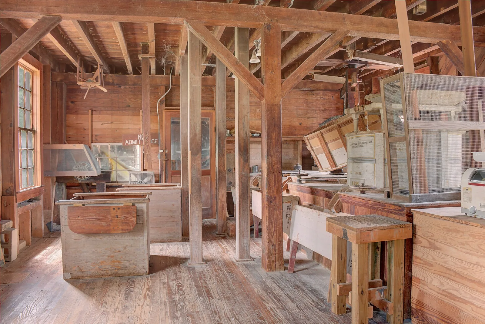 Wood-framed mill interior with milling machinery