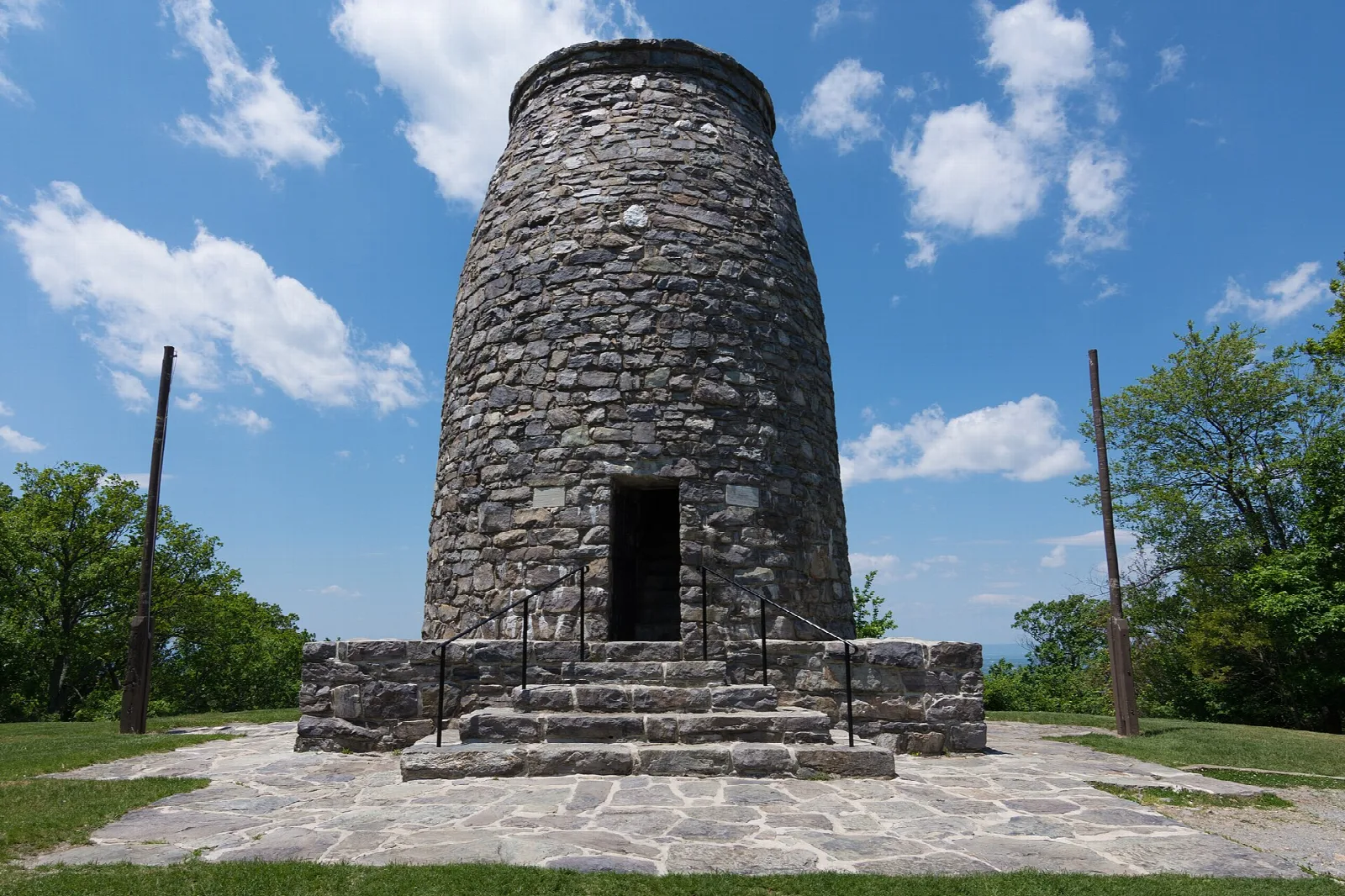 Round stone tower with an open doorway and steps