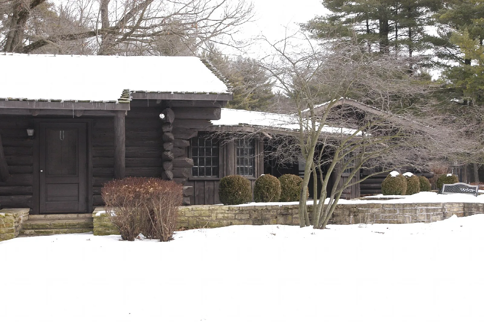 Log lodge building with snow on the ground