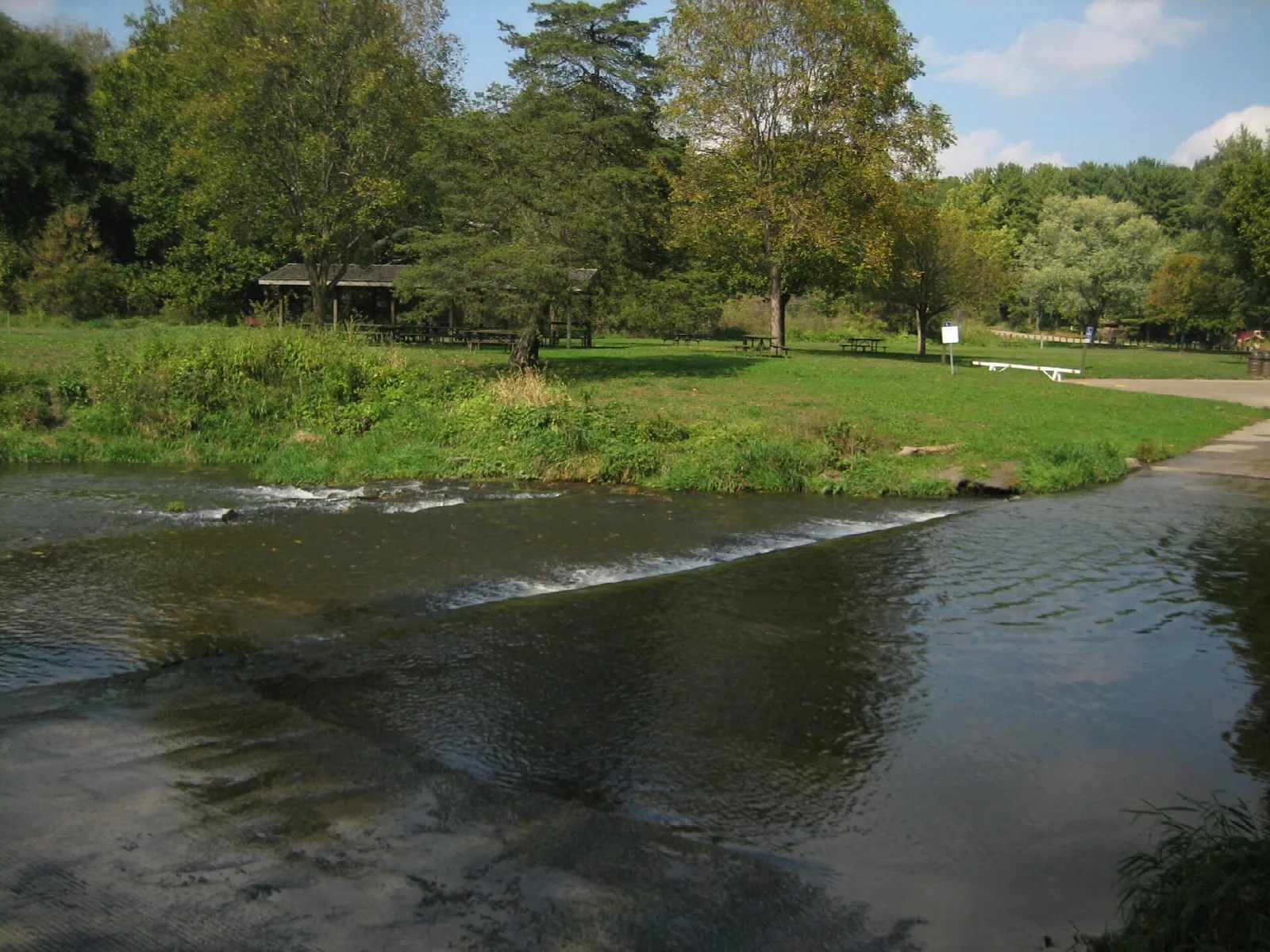Shallow ford across Pine Creek with trees and lawn beyond