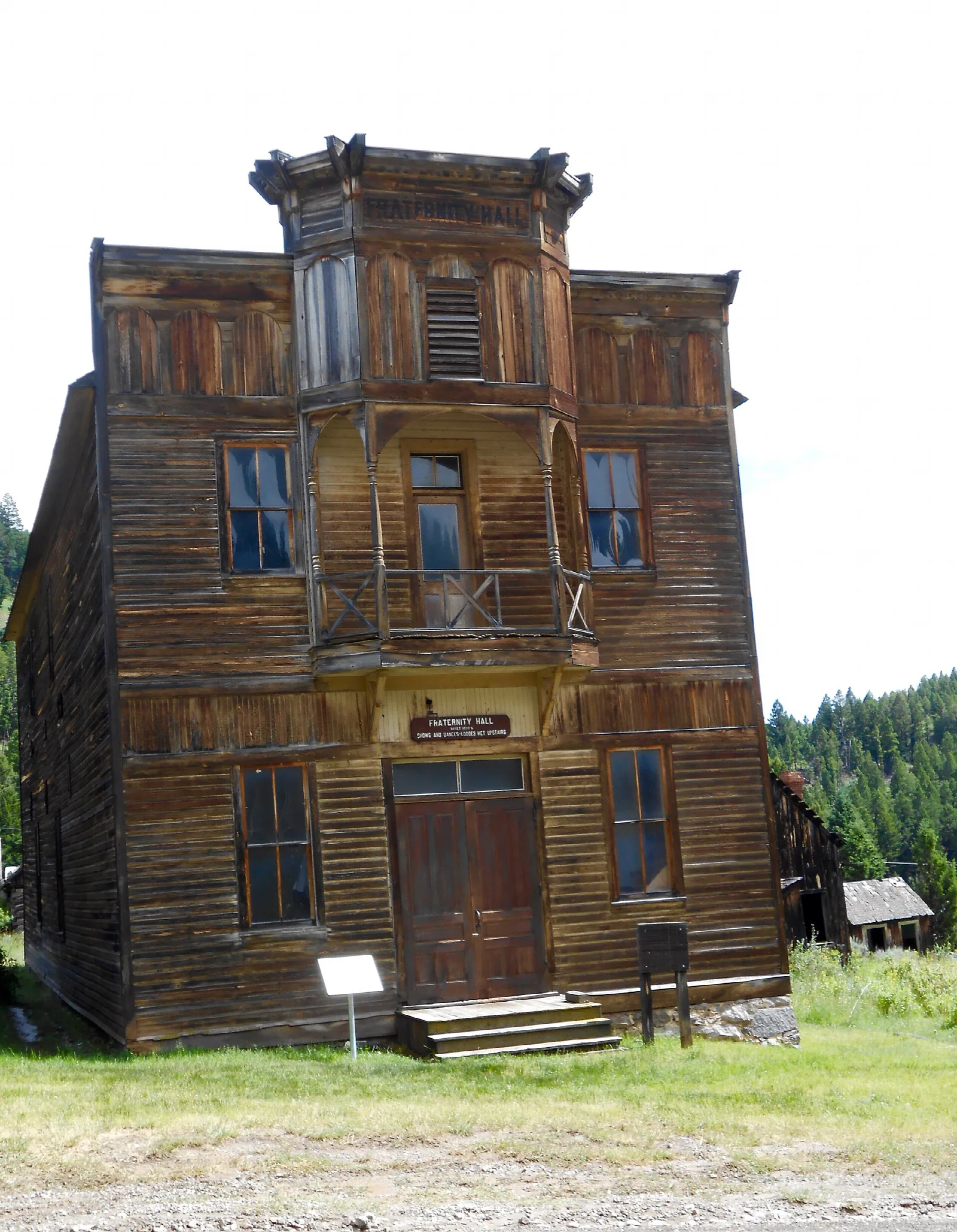 Tall weathered wooden hall with a gabled front