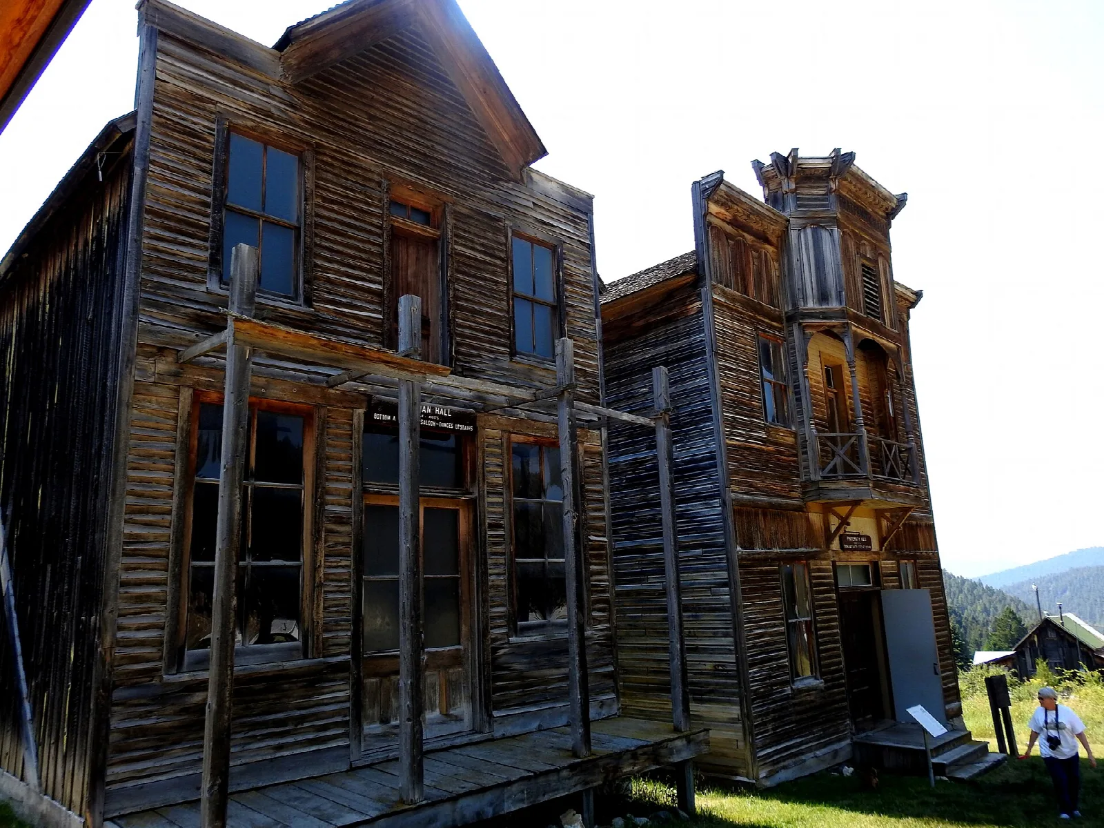 Two tall weathered wooden buildings side by side