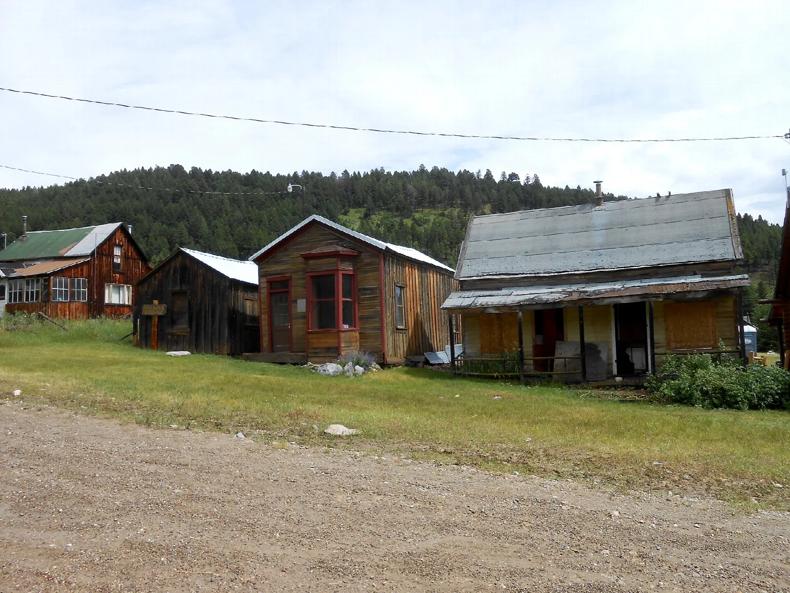 Old wooden houses beside a gravel road