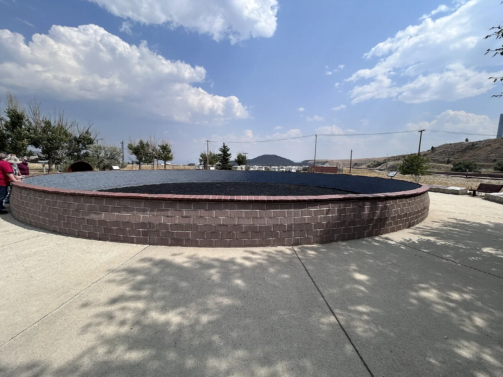 Round brick viewing wall on a paved plaza
