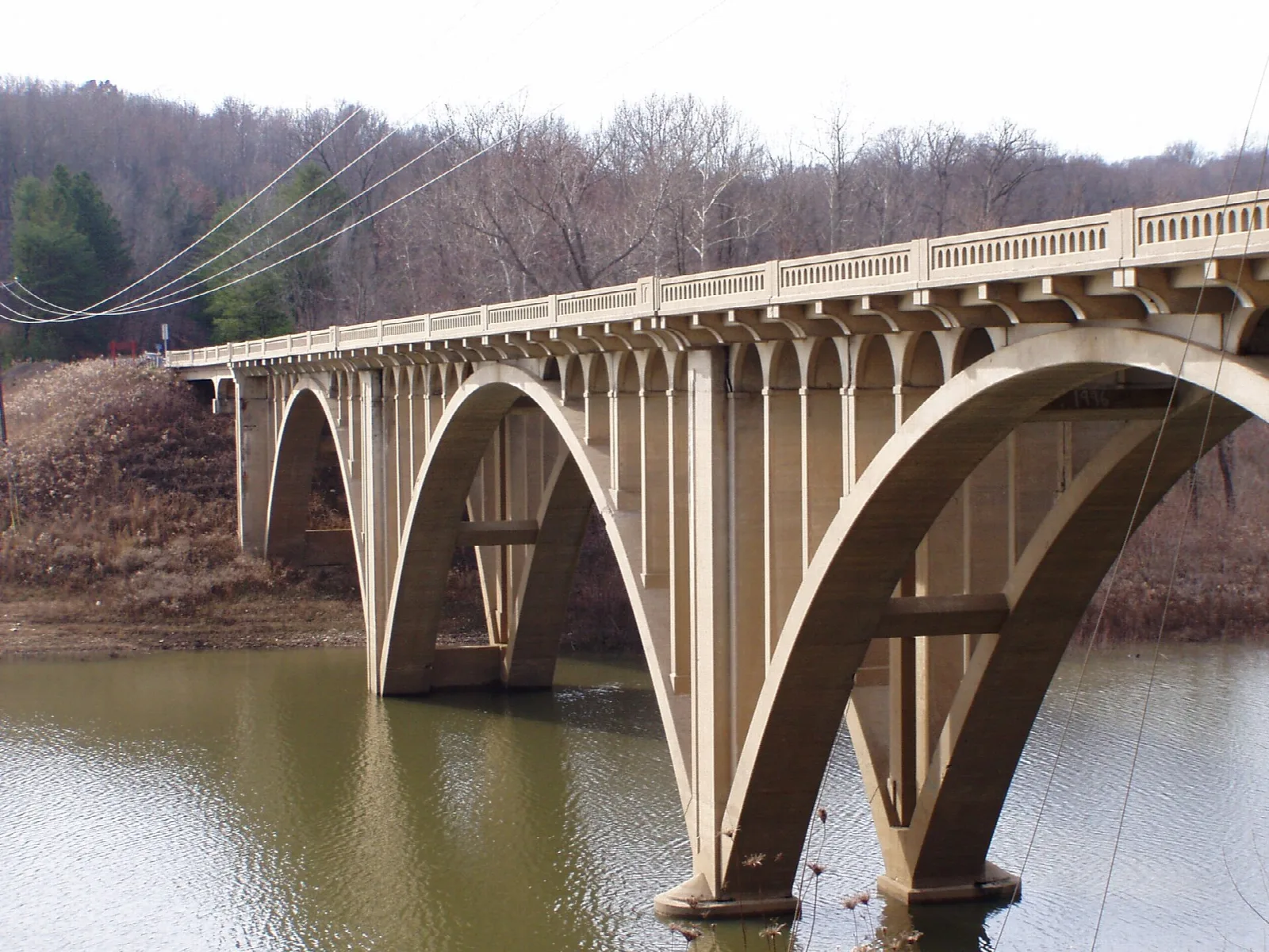 Concrete arch bridge crossing a reservoir