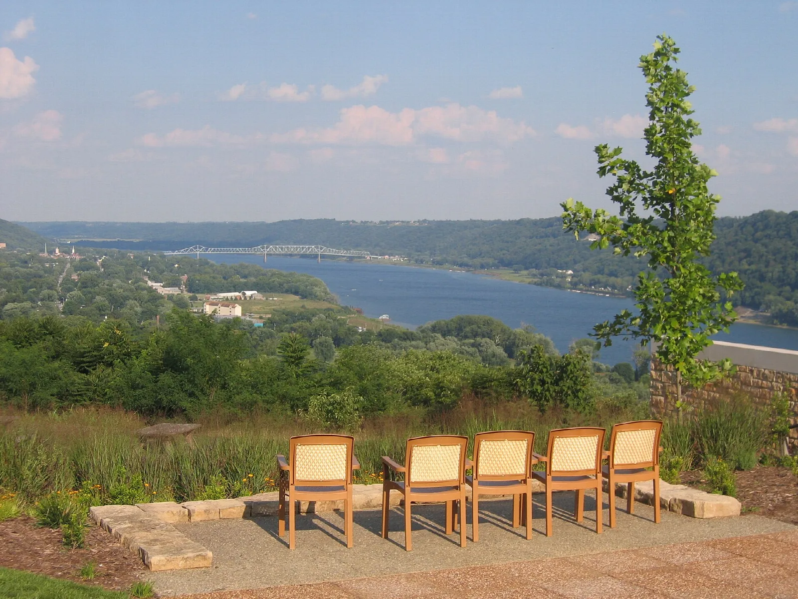 Chairs on a stone patio overlooking the Ohio River valley