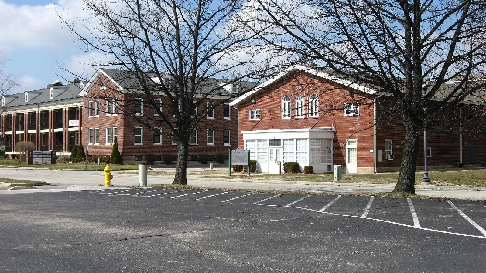 Red brick buildings facing an empty parking area