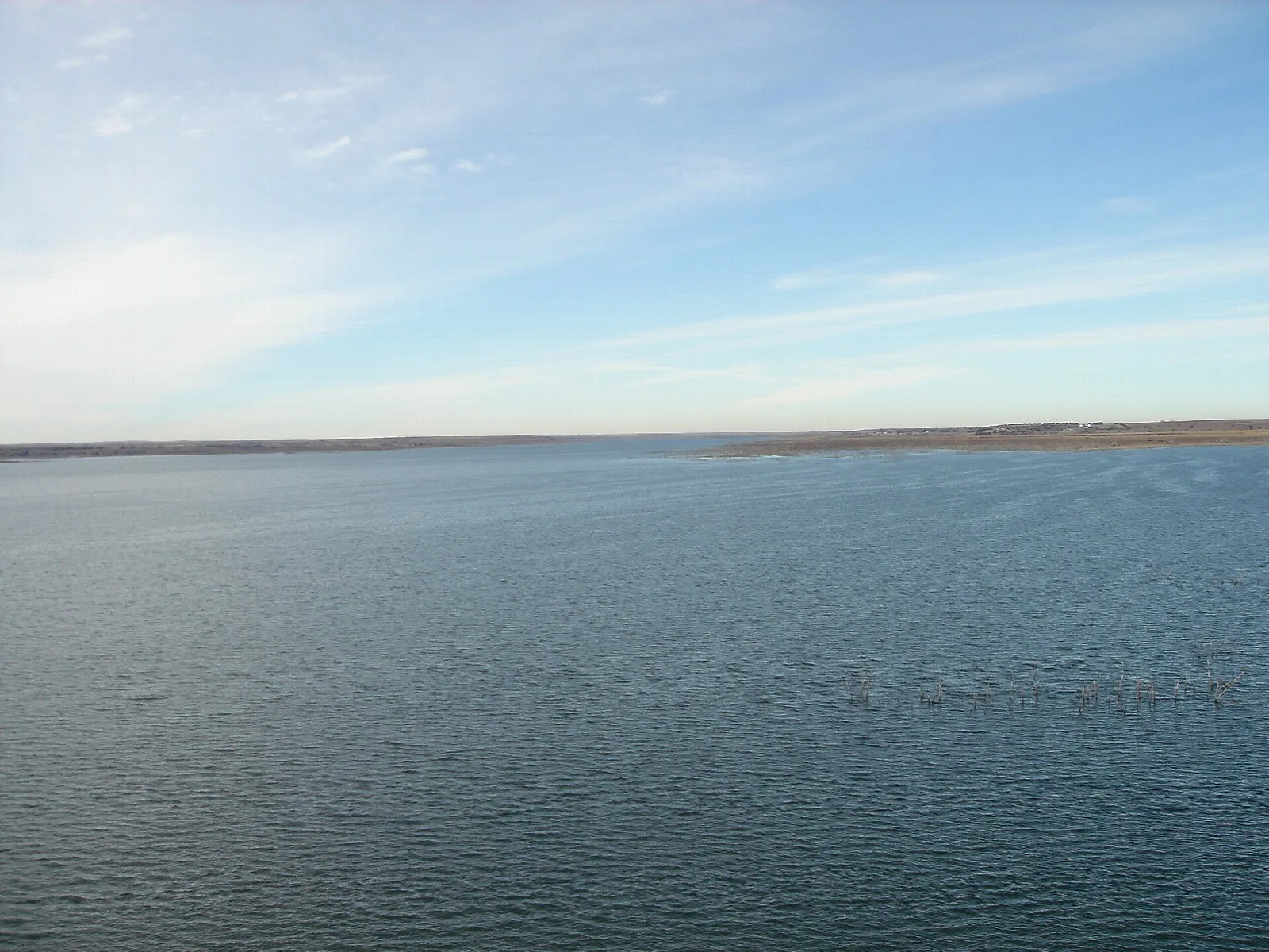 Open reservoir under a pale sky with a flat far shore