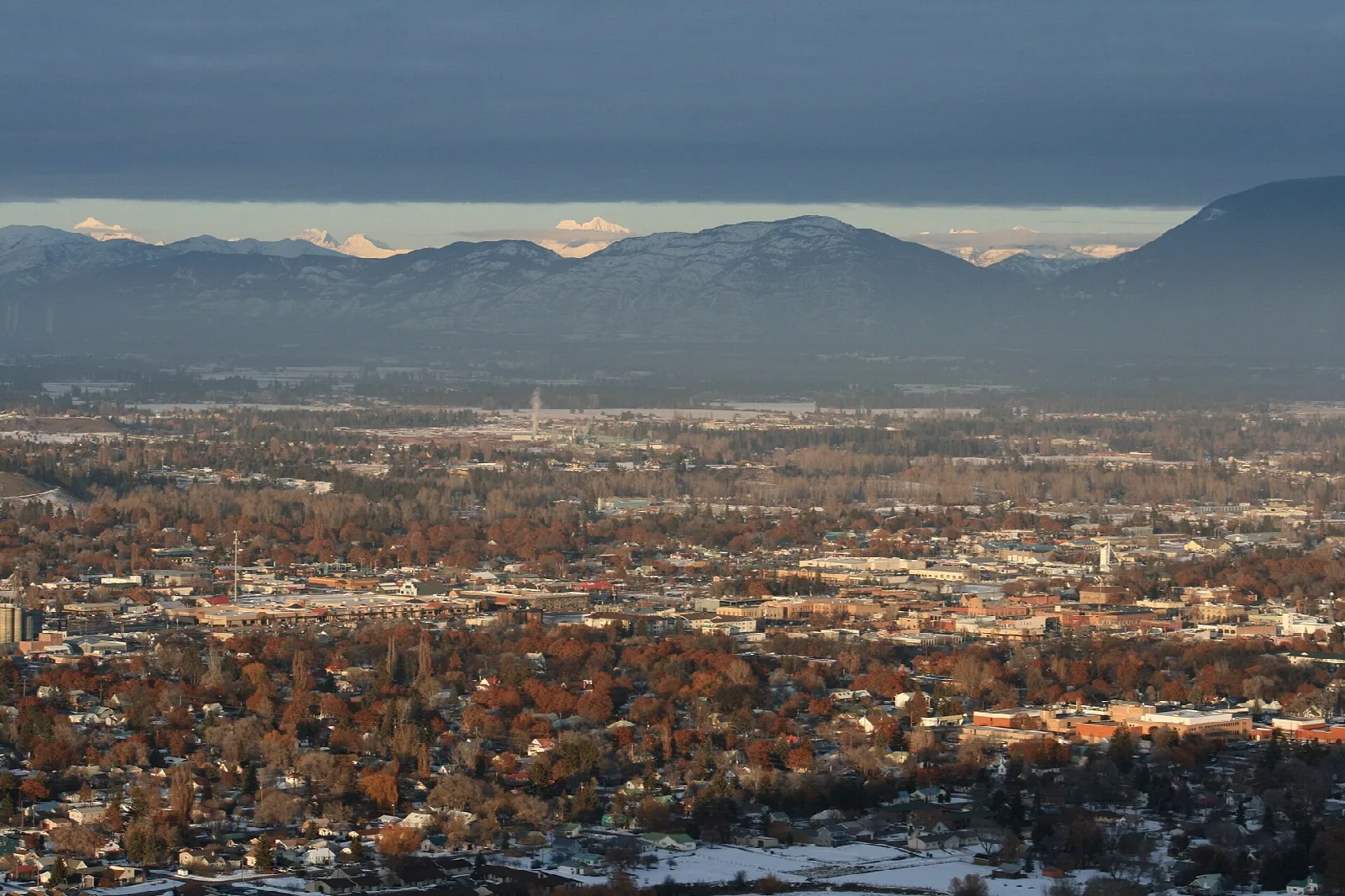 Kalispell and the Flathead Valley seen from above, with distant mountains on the horizon