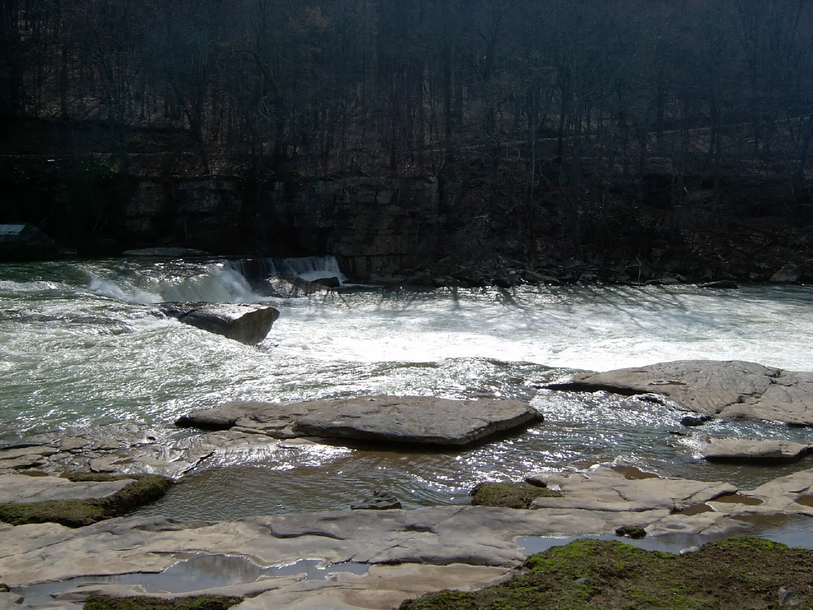 White water rushing over flat rock ledges in a river