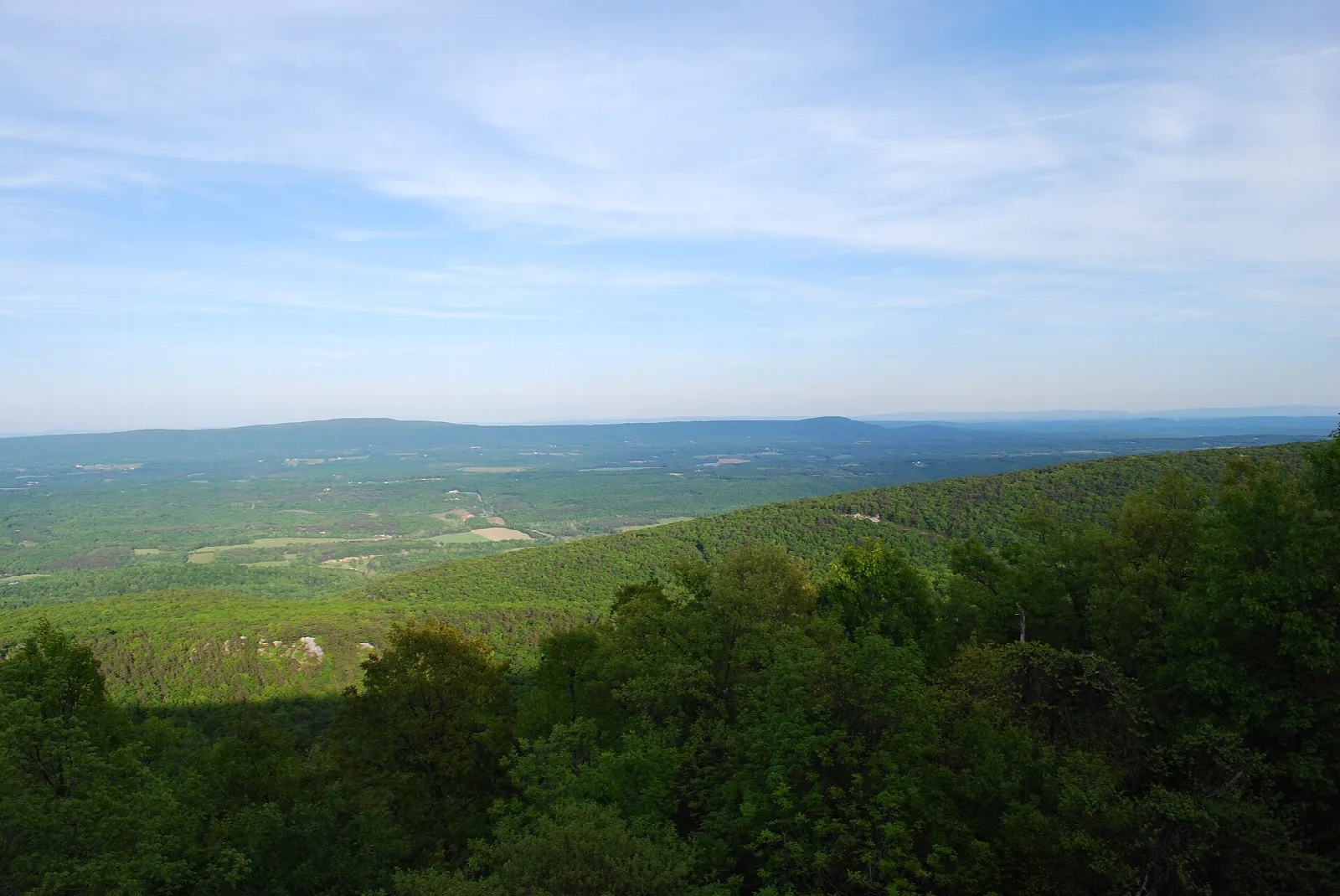 Wide view of green ridges and valley from a mountain overlook