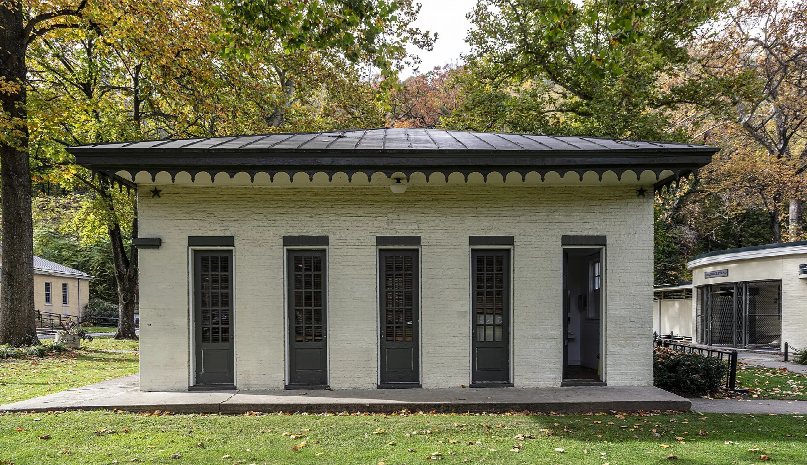 Long single-story cream building with tall dark doors