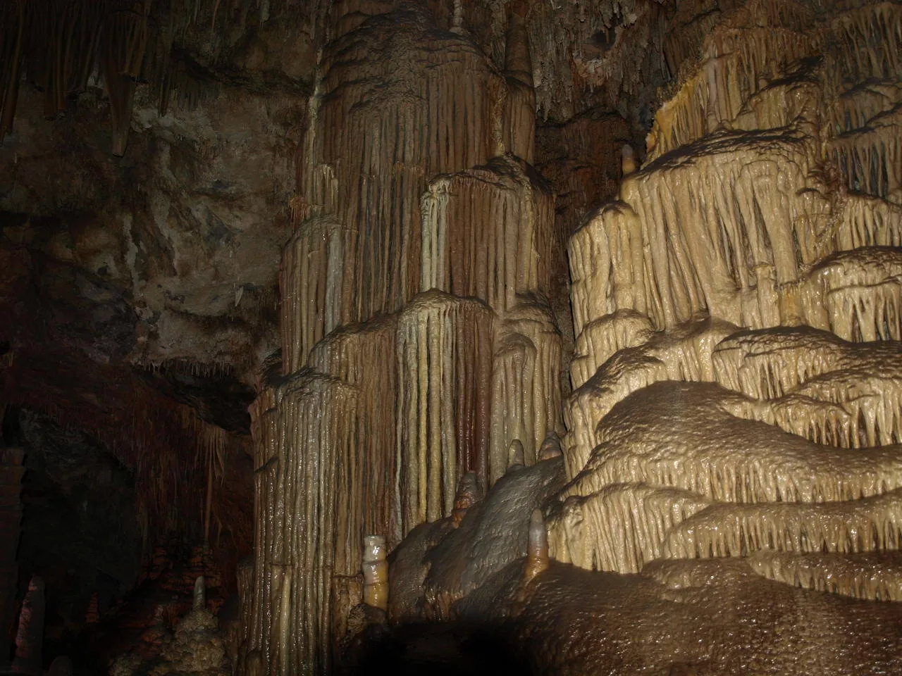 Tall layered limestone formations inside a cave