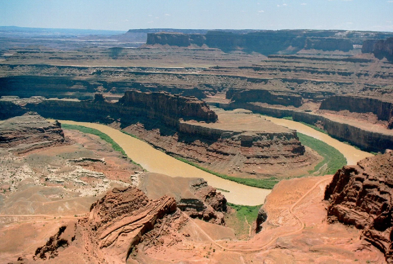 Colorado River winding through a deep red rock canyon seen from the overlook