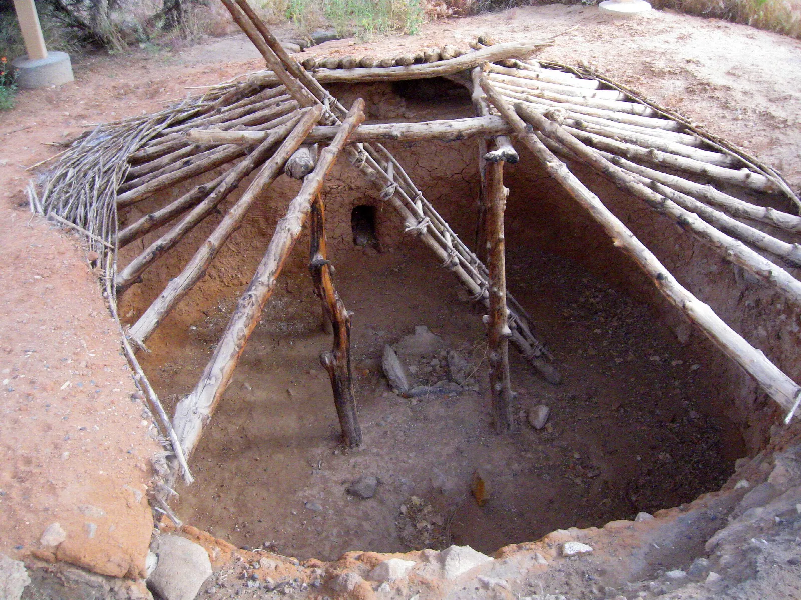 Pithouse with a log roof frame over a round pit