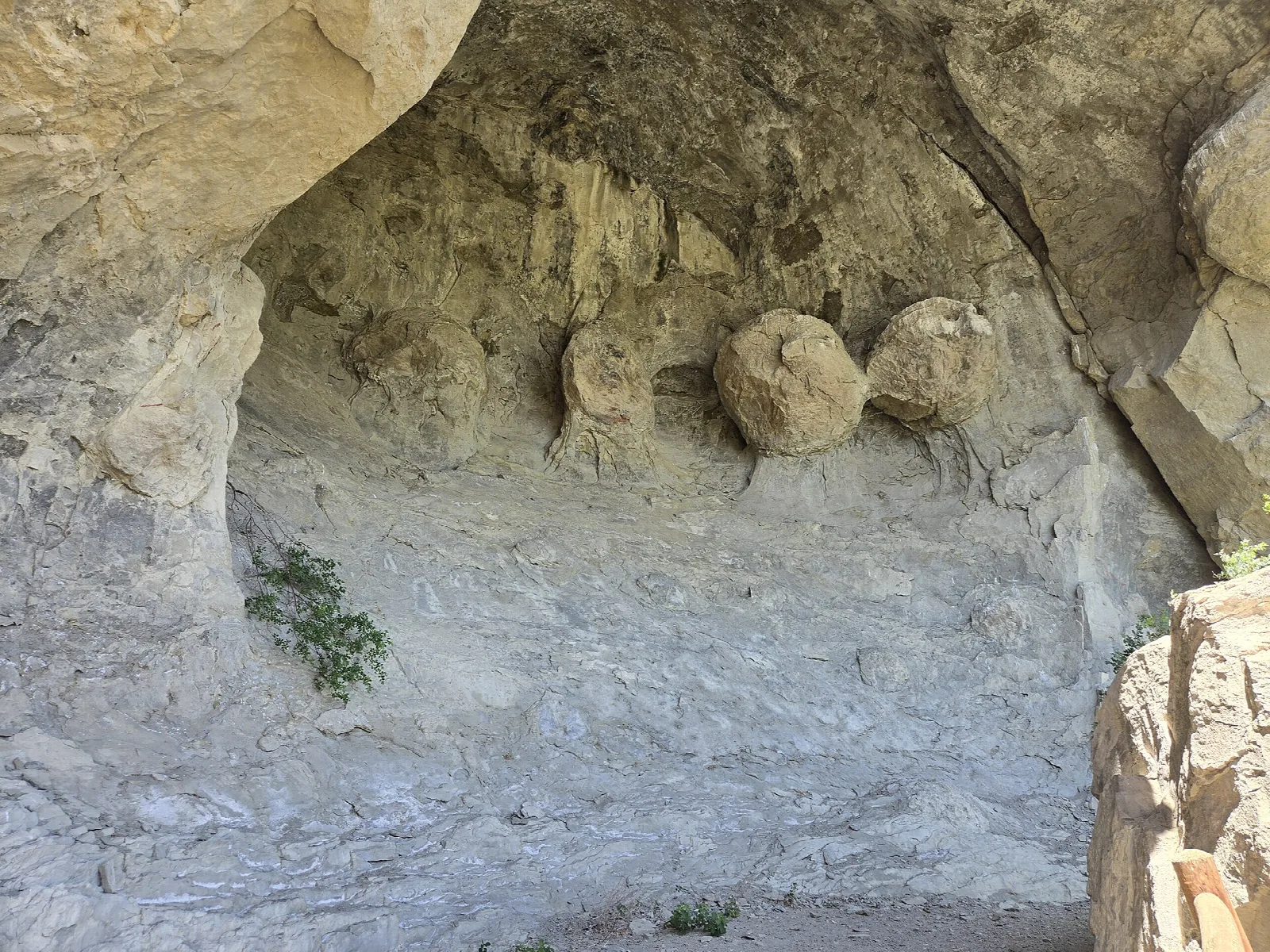 Sandstone cave with rounded boulders on the floor
