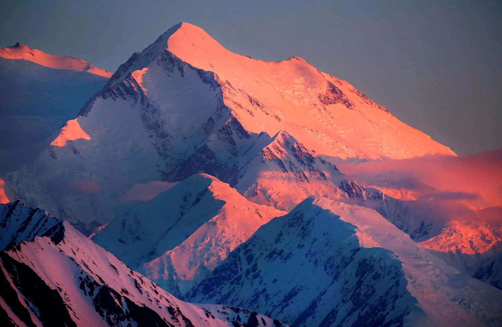 Pink evening light on the snowy summit ridges of North America's tallest peak
