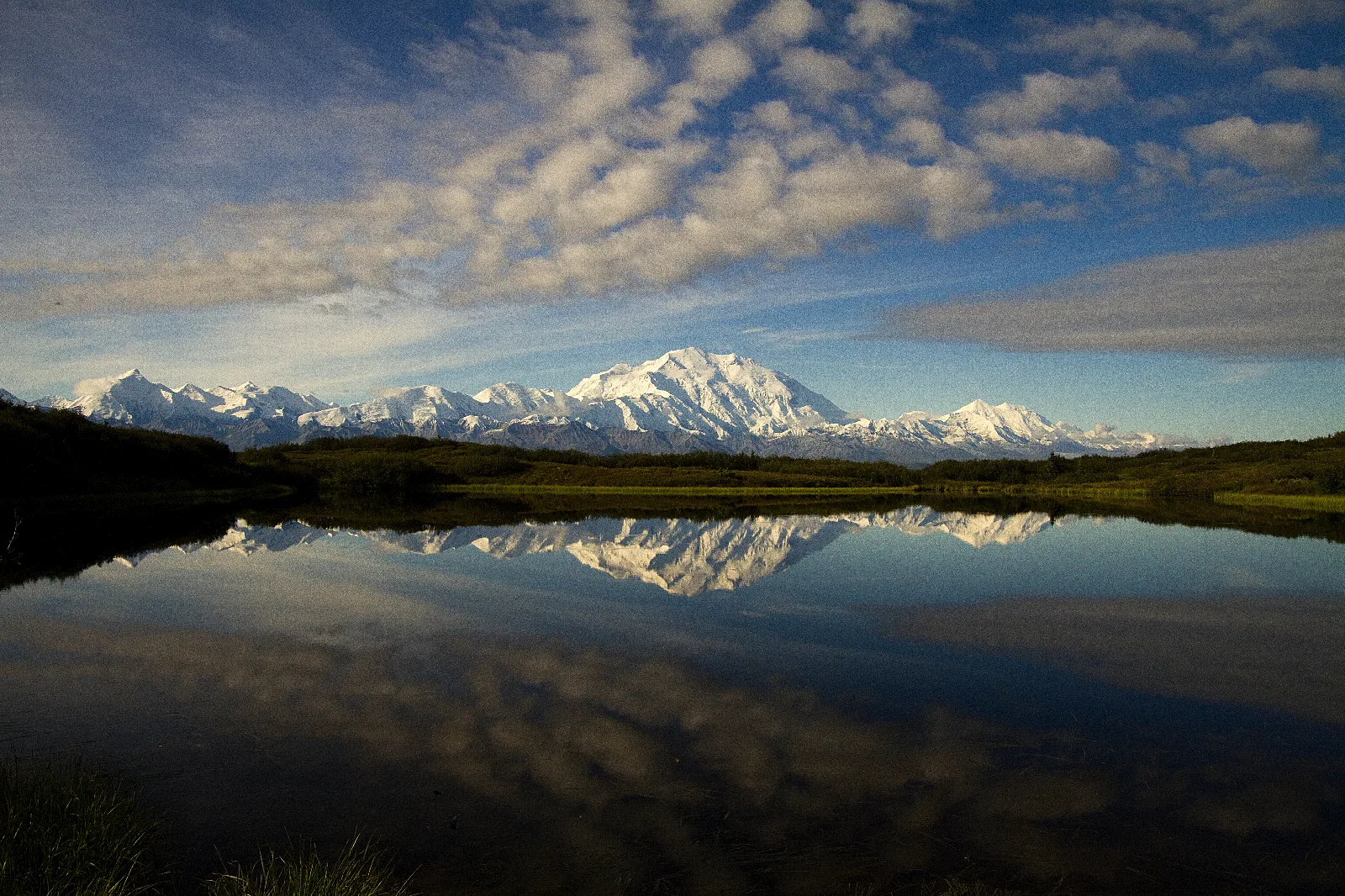 snowy mountains reflected in a pond