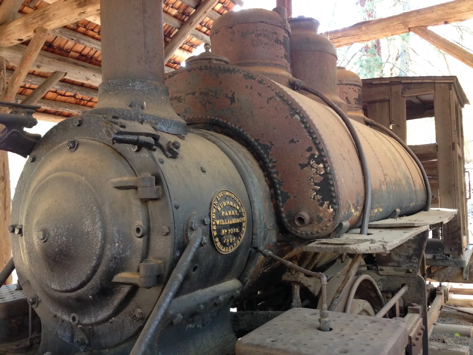 Old steam locomotive boiler under a roof