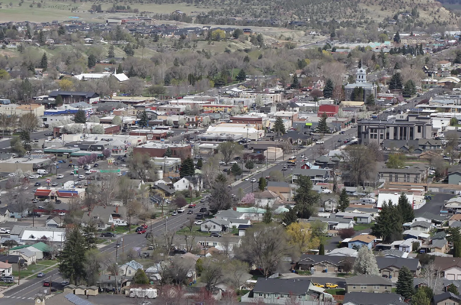 Hillside view over the rooftops and streets of a small town in a valley