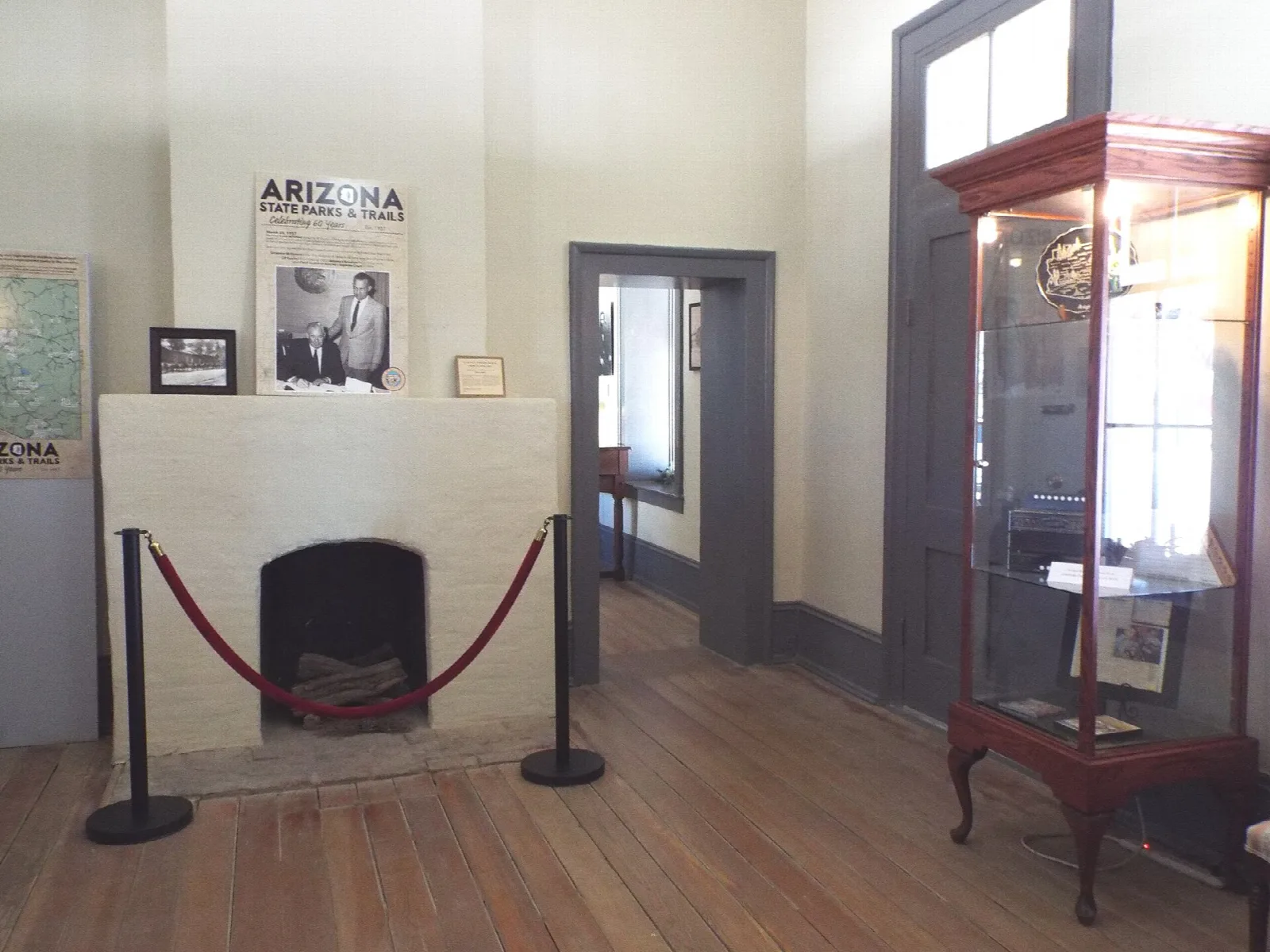Museum room with a fireplace and display case
