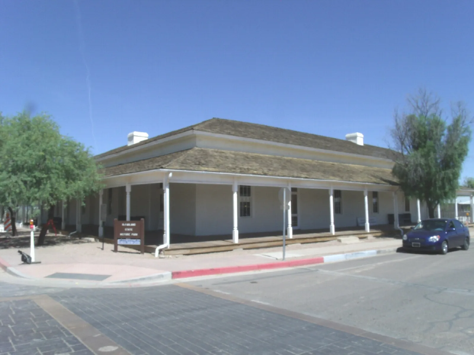 Courthouse building with a wide porch seen from a corner