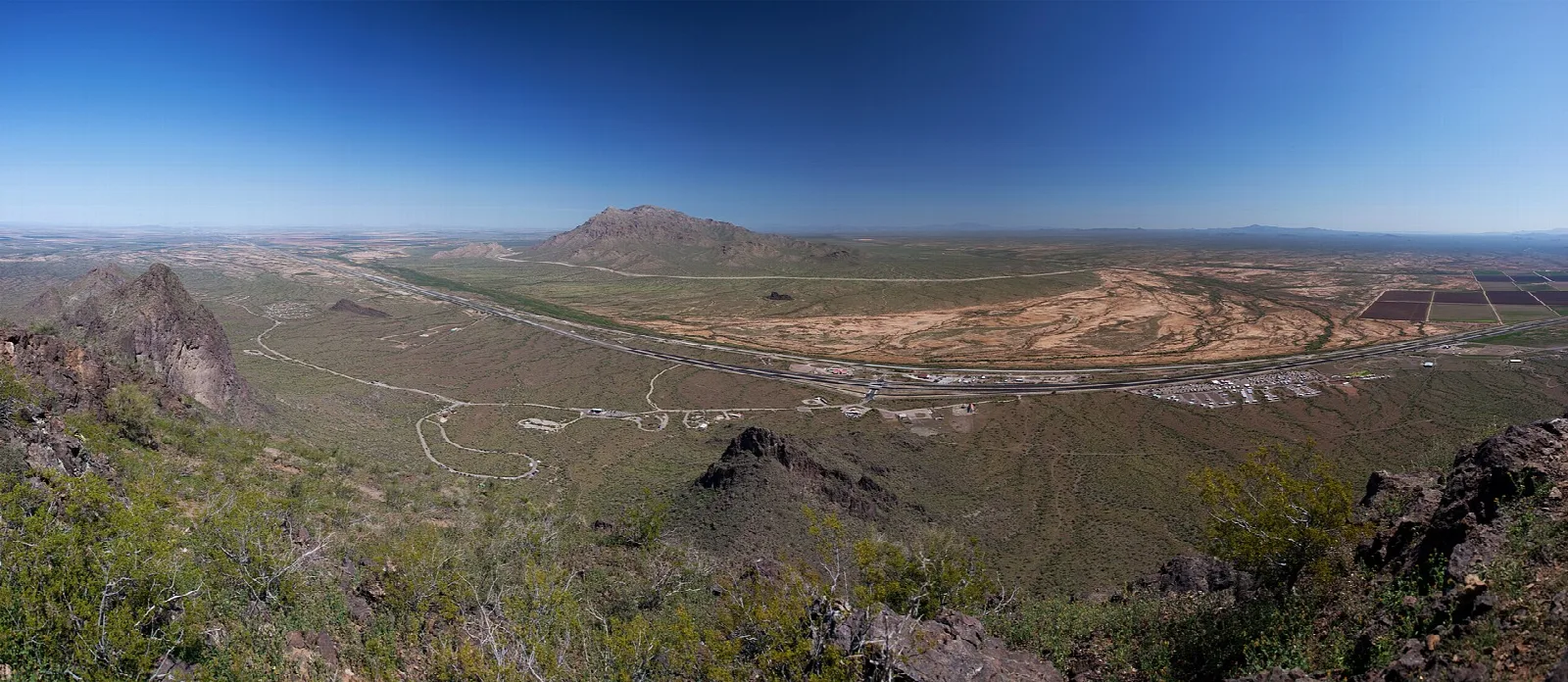 Wide view of desert and farmland from the top of the peak