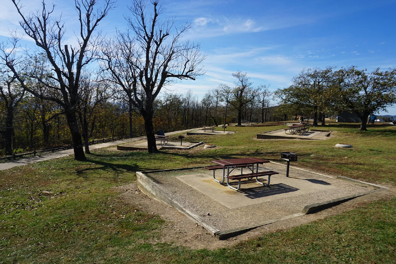 Hilltop picnic area with a table on a concrete pad and bare trees
