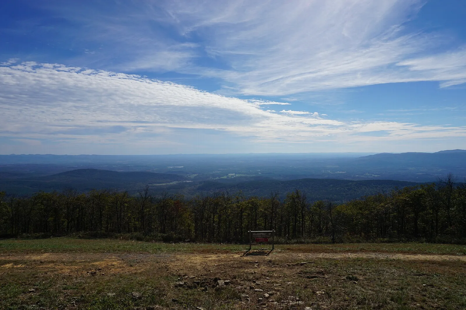 Long view over forested ridges and valleys from a mountaintop clearing