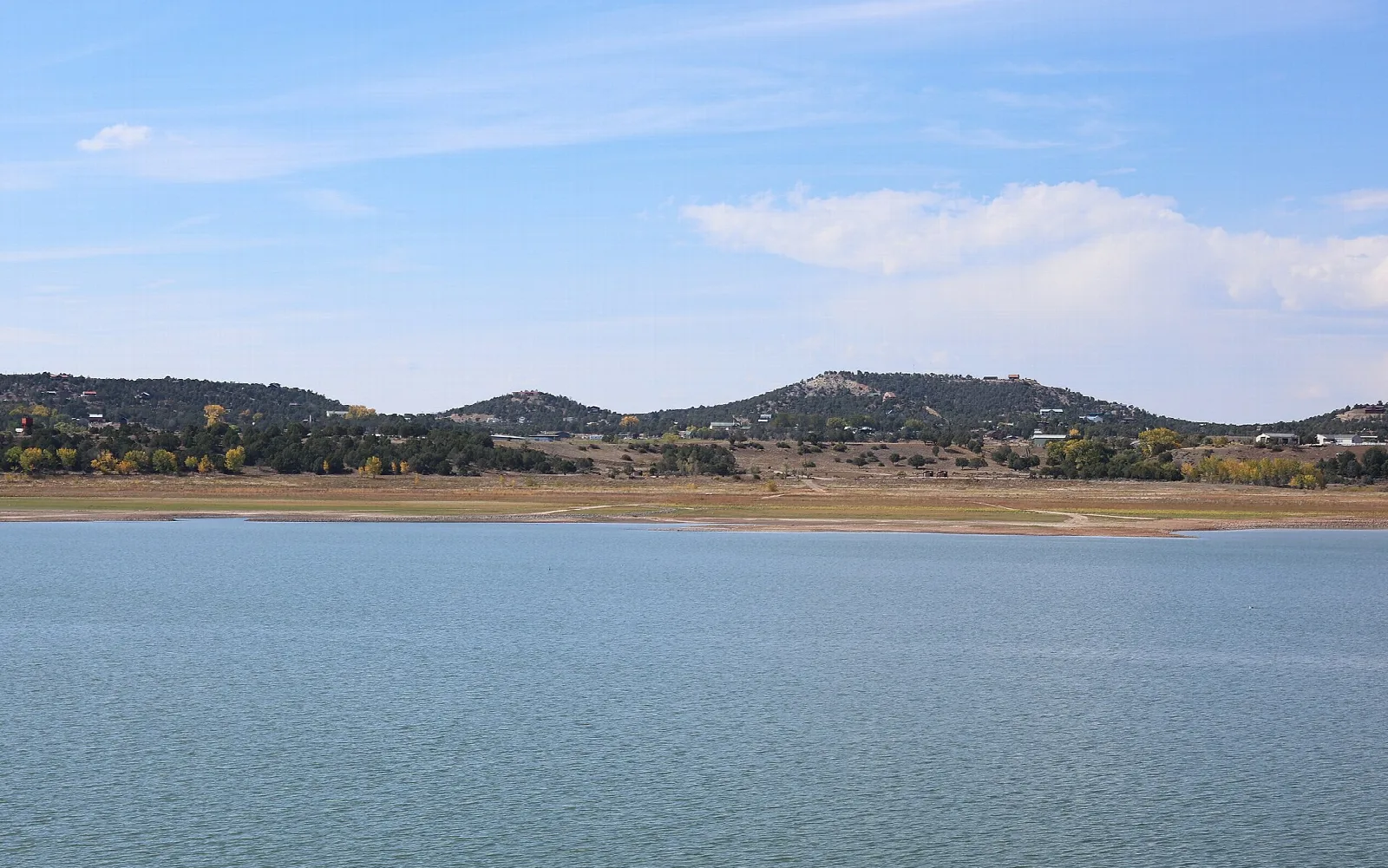 Wide lake with low hills and a pale shoreline