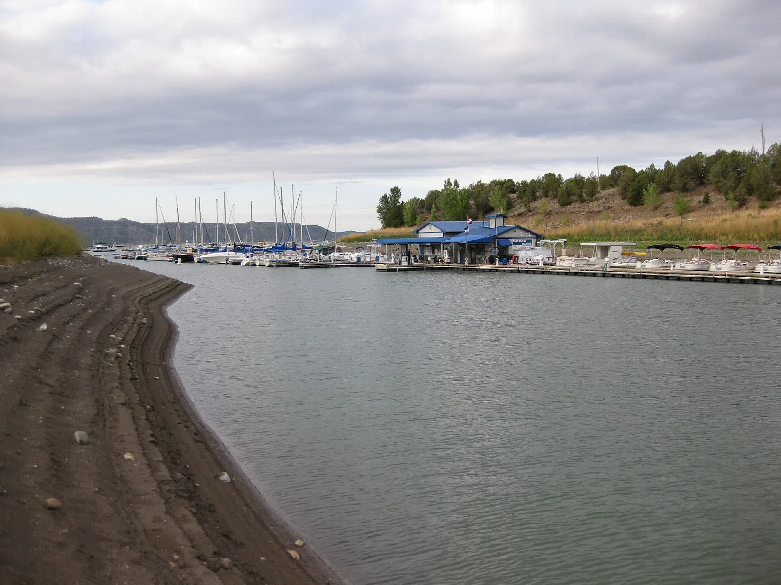 Curving shoreline leading to a marina with boats