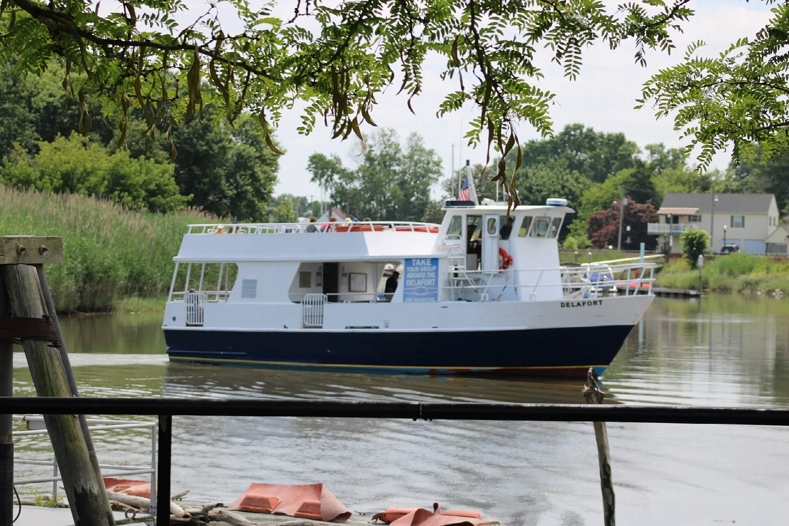 White passenger ferry tied up at a dock