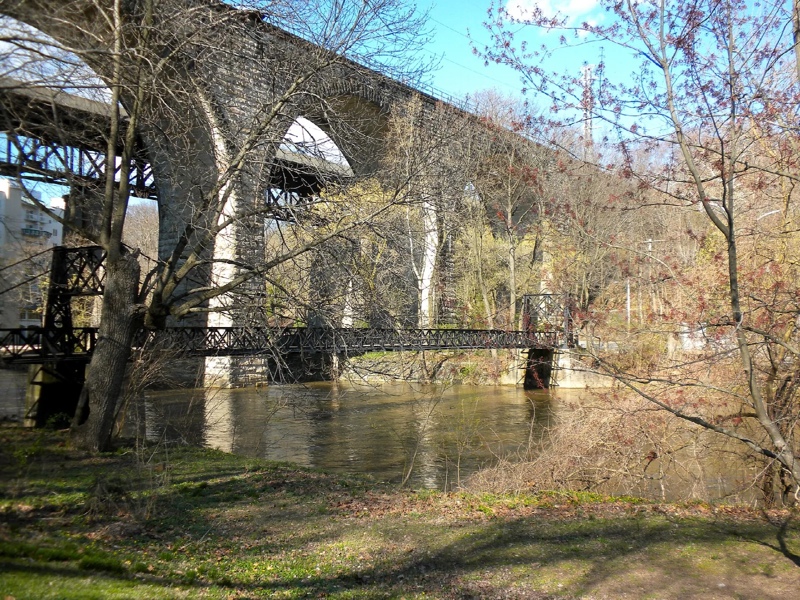 Stone arch bridges and a small footbridge over the creek