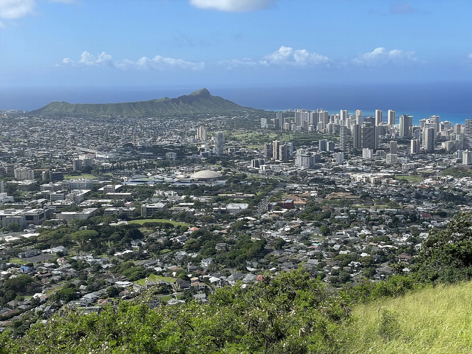 Honolulu buildings below with Diamond Head on the horizon