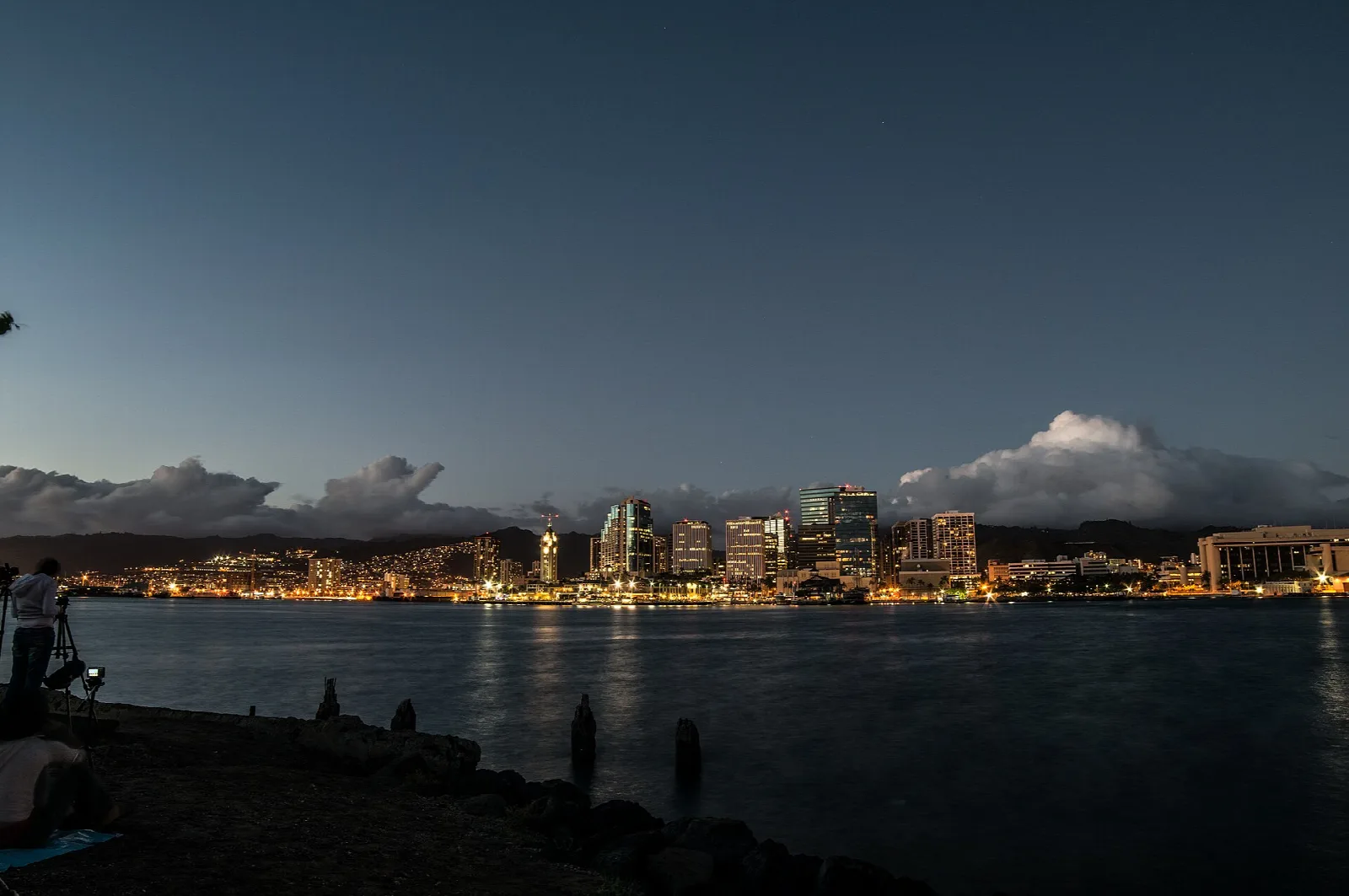 Downtown Honolulu lights across the water at dusk