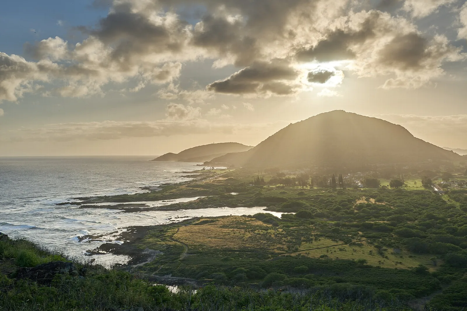Sun rays through clouds over Koko Head and the coast