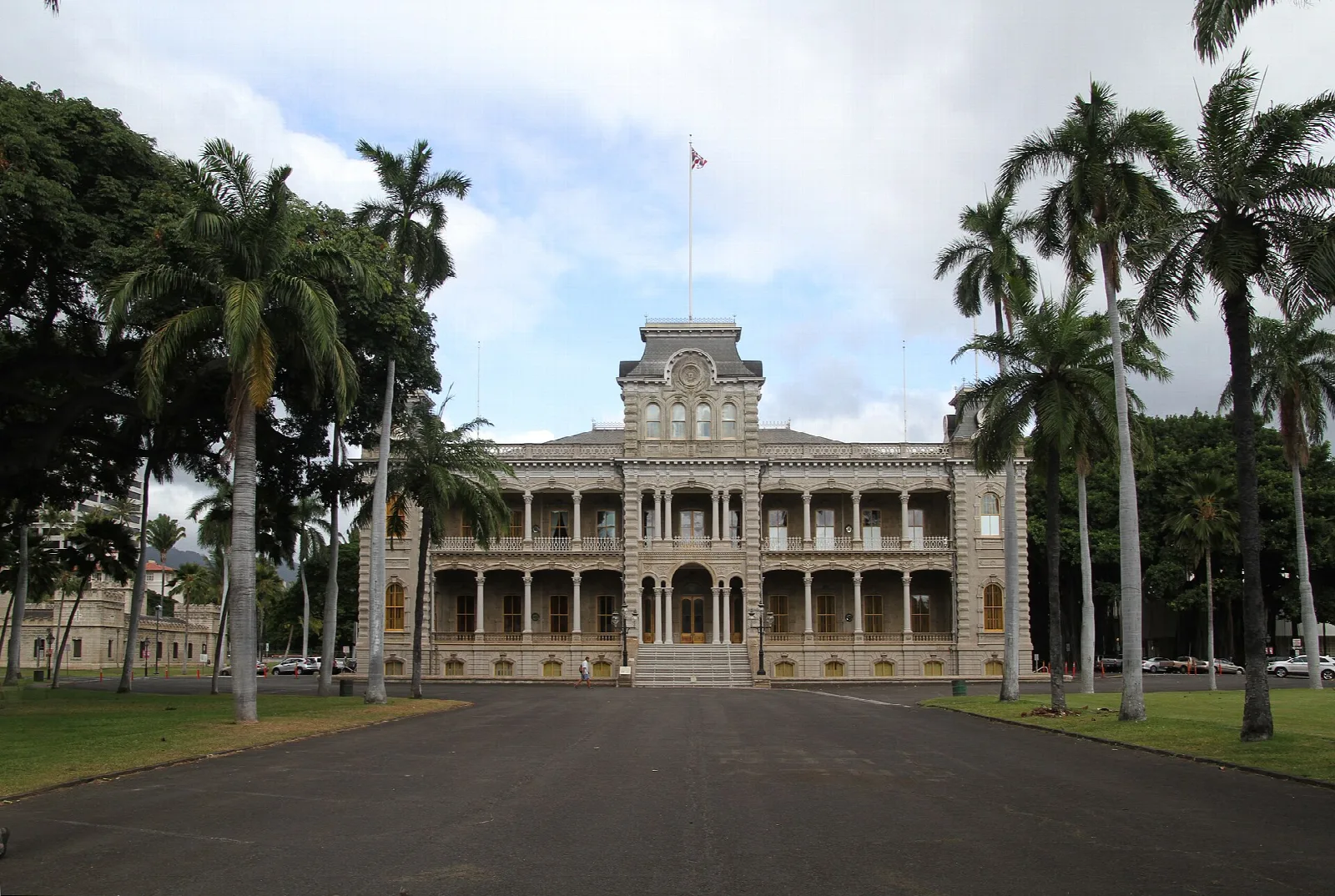 Palms along a driveway leading to the palace across a lawn