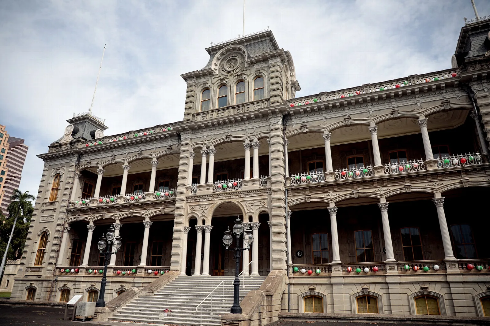 Palace facade with wide steps and verandas under a cloudy sky