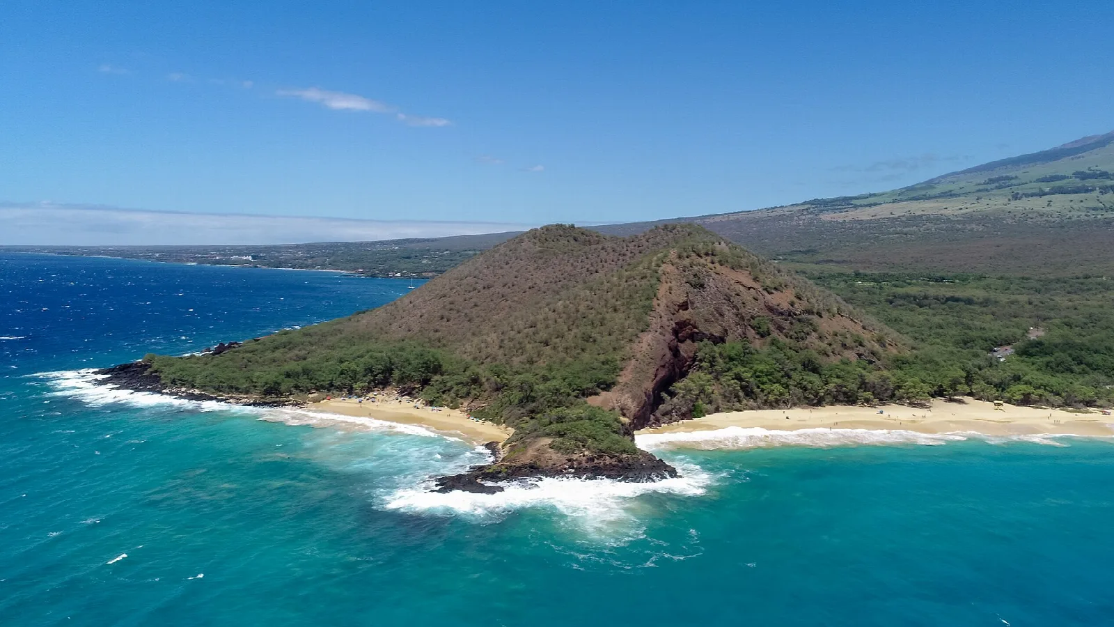 Aerial view of the cinder cone meeting the sea beside two beaches