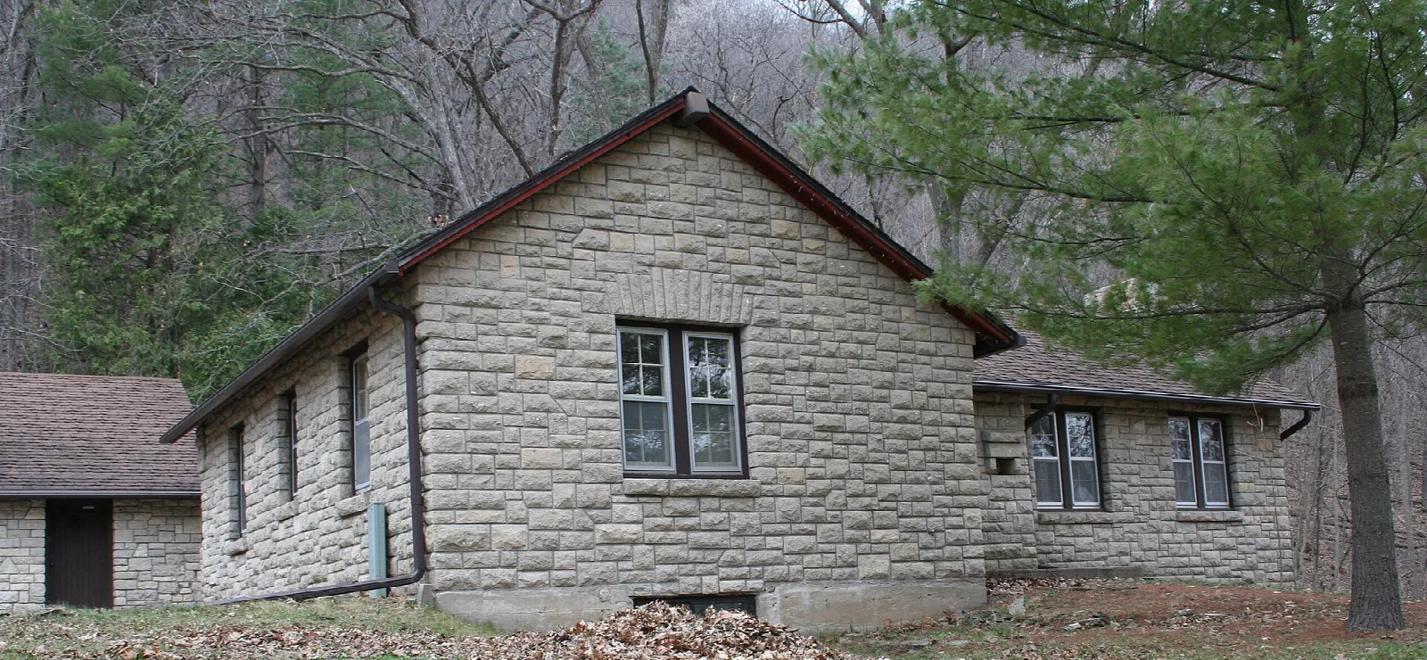 Stone caretaker's cabin among trees