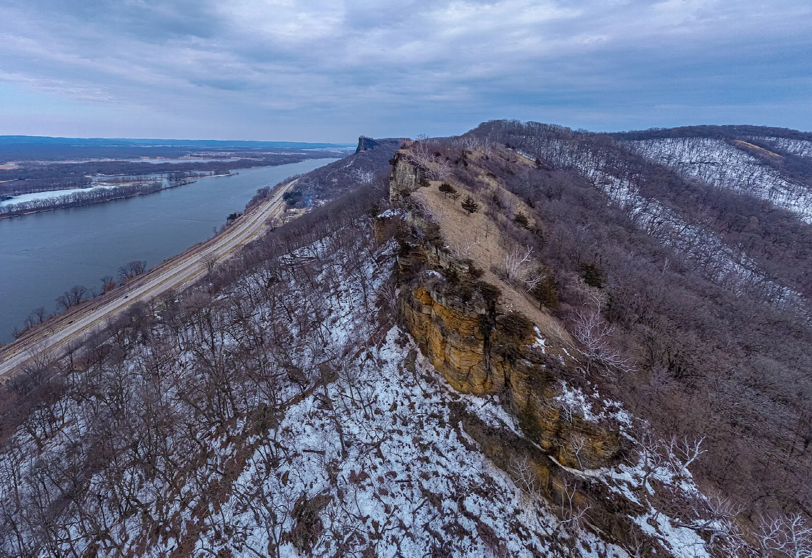 Rocky bluff ridge with light snow above the Mississippi River