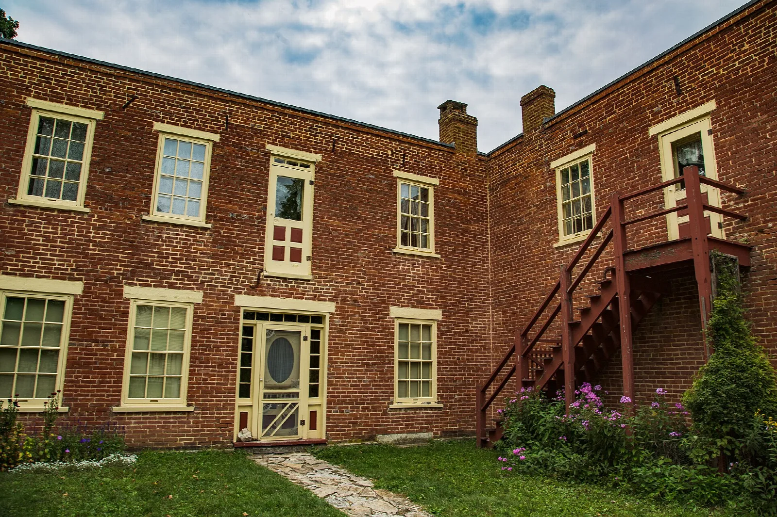 Two-story brick building with a staircase on the side