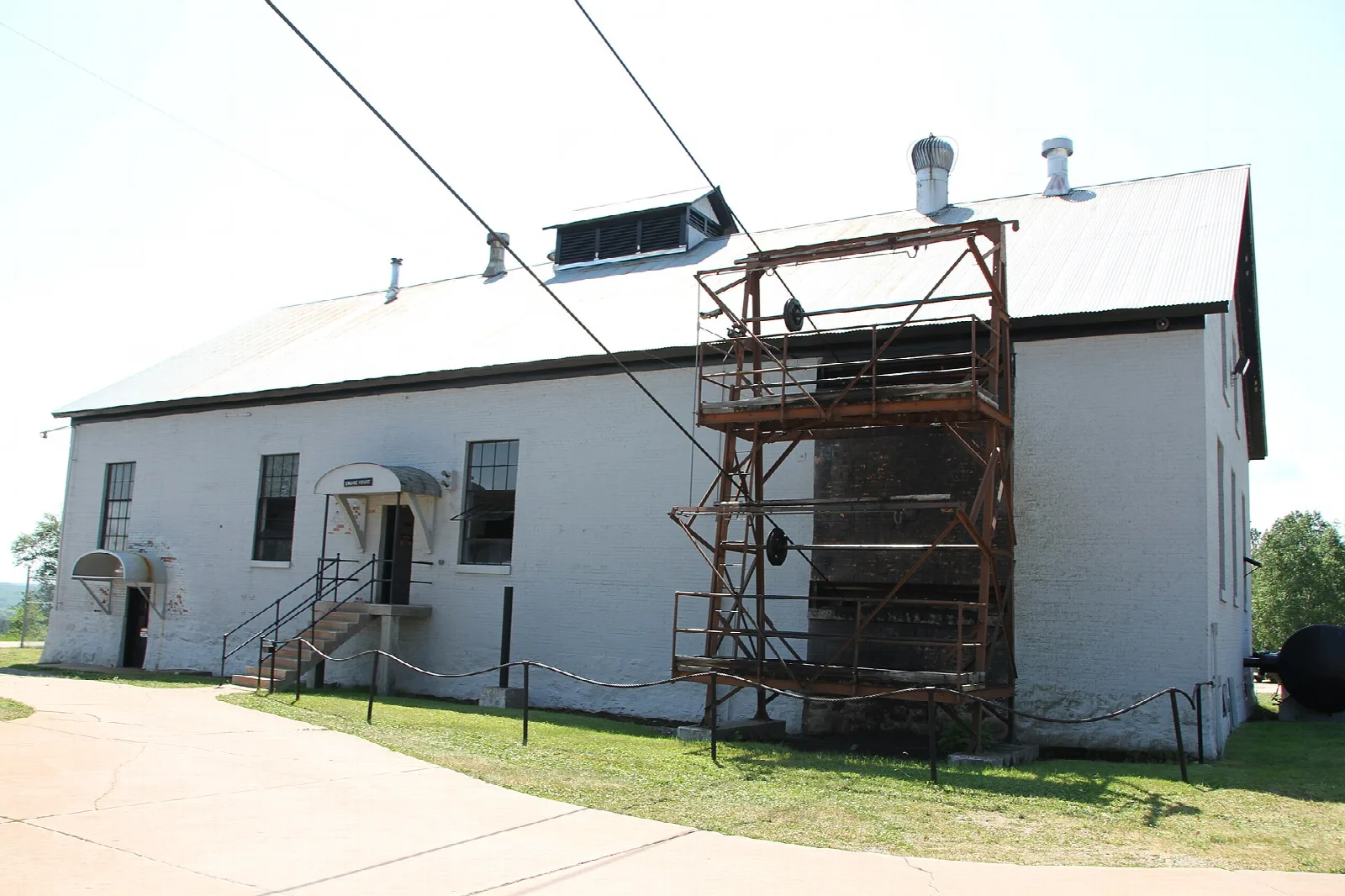 White mine building with a steel tower and cables
