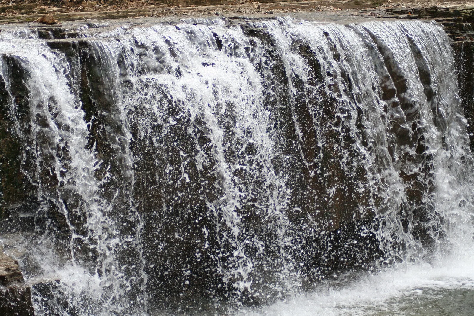 Wide waterfall spilling over a rock ledge