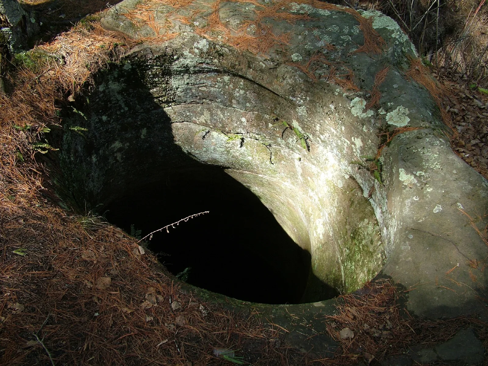Round stone pothole carved into rock