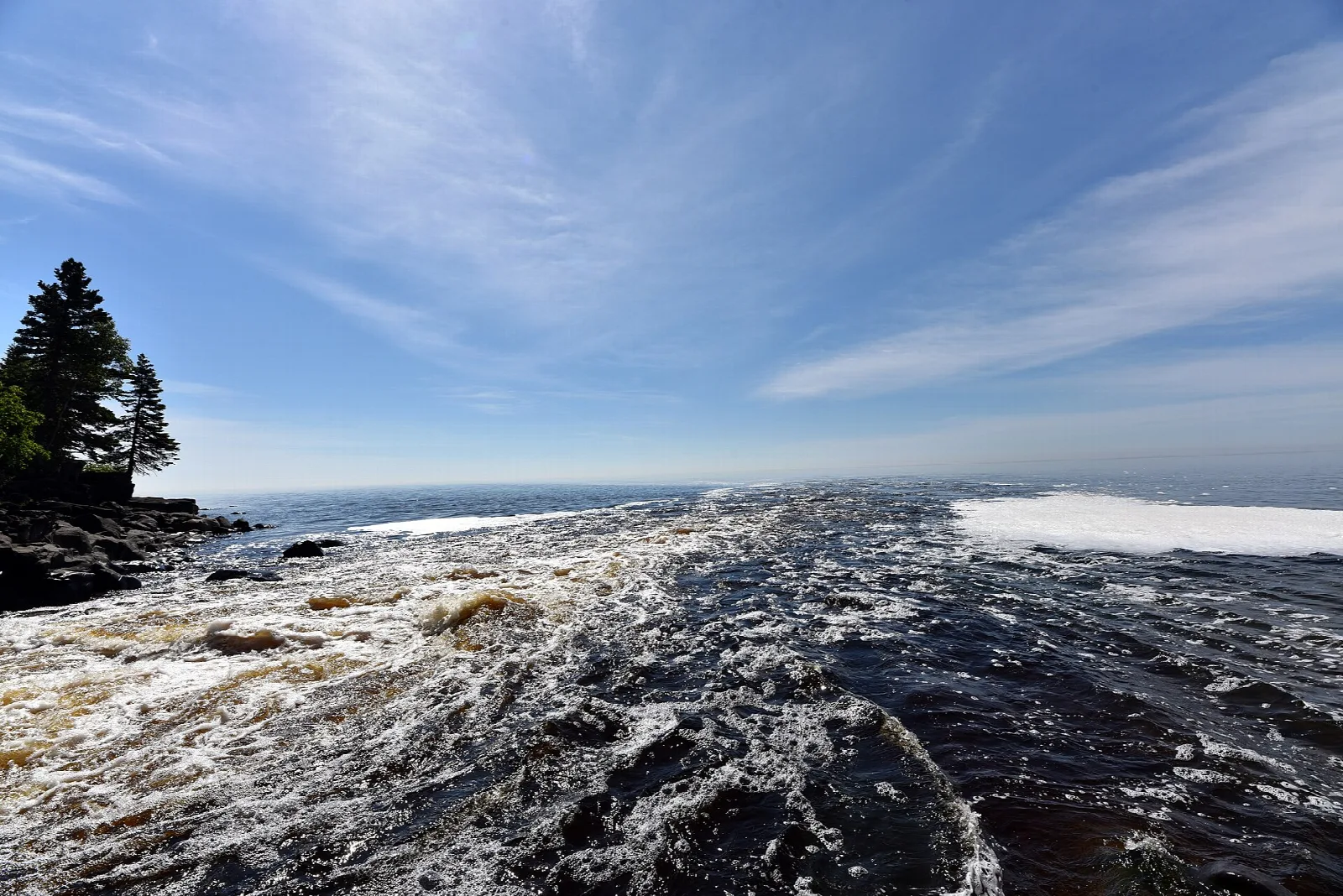 River water rushing over dark rock toward Lake Superior